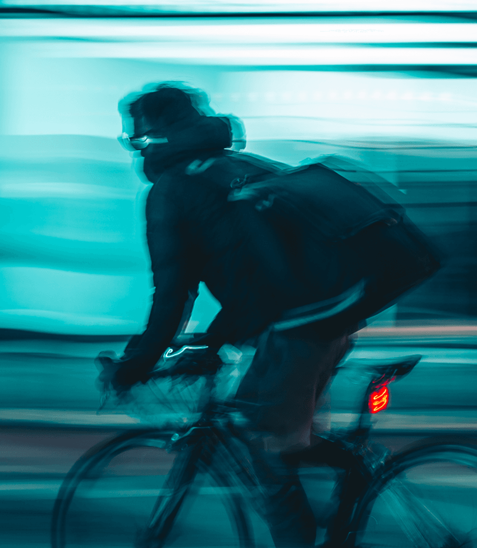 Cyclist riding through a city at night.