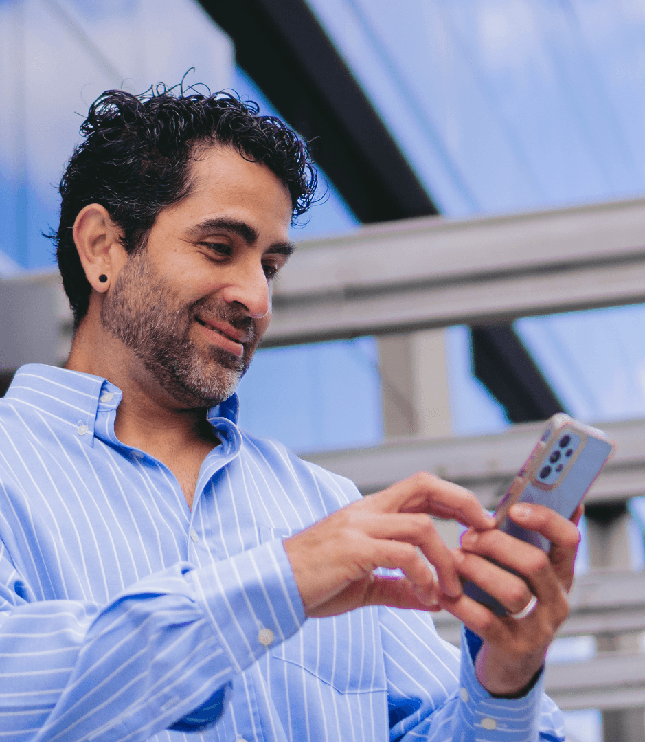Man using a smartphone indoors.